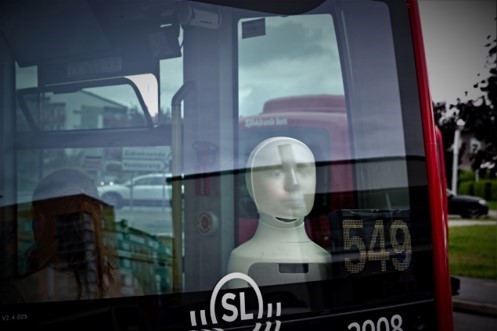 Furhat installed in a driverless bus, seen from the outside.