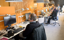 Man sitting in front of a computer at an office