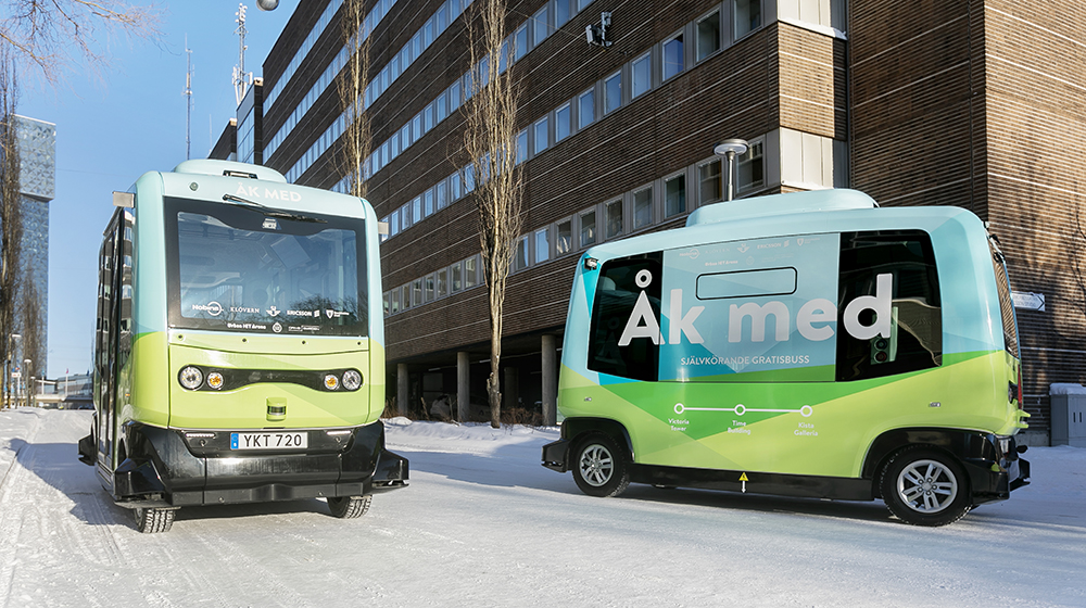 Autonomous buses on a snowy road.